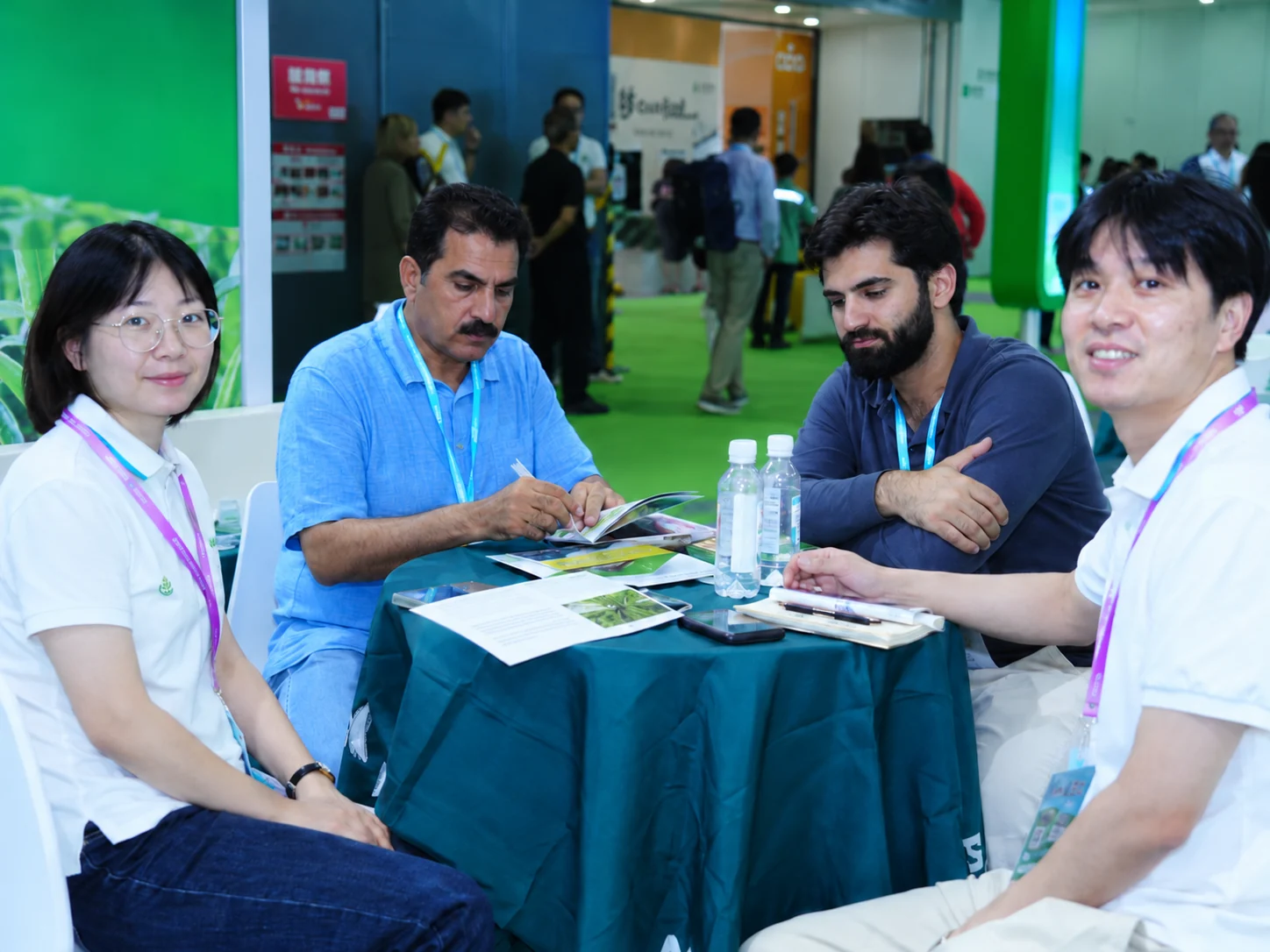 People reviewing printed product information around a round table.